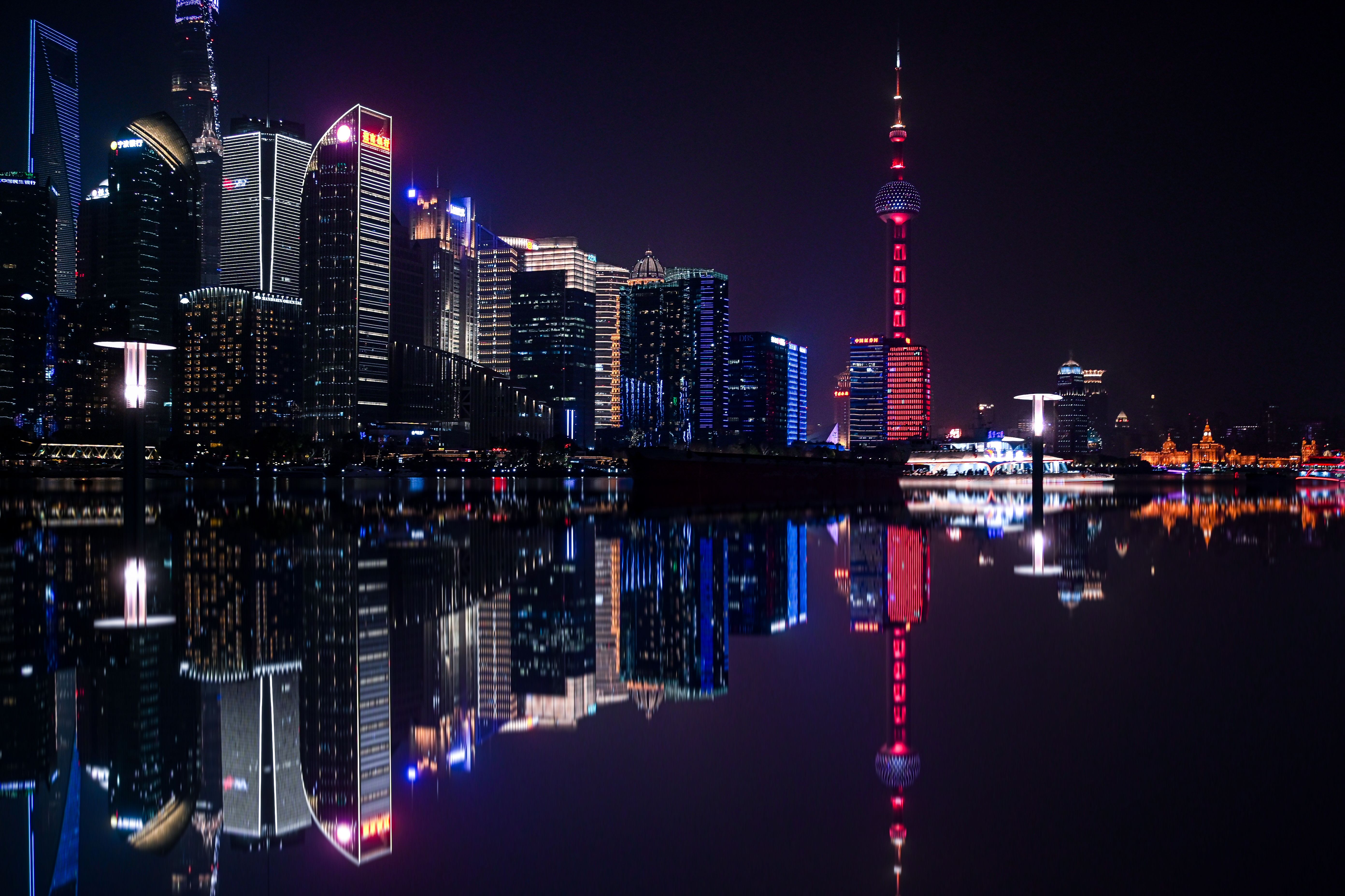 Dazzling night view of Shanghai's Pudong skyline with the iconic Oriental Pearl Tower reflecting on the Huangpu River