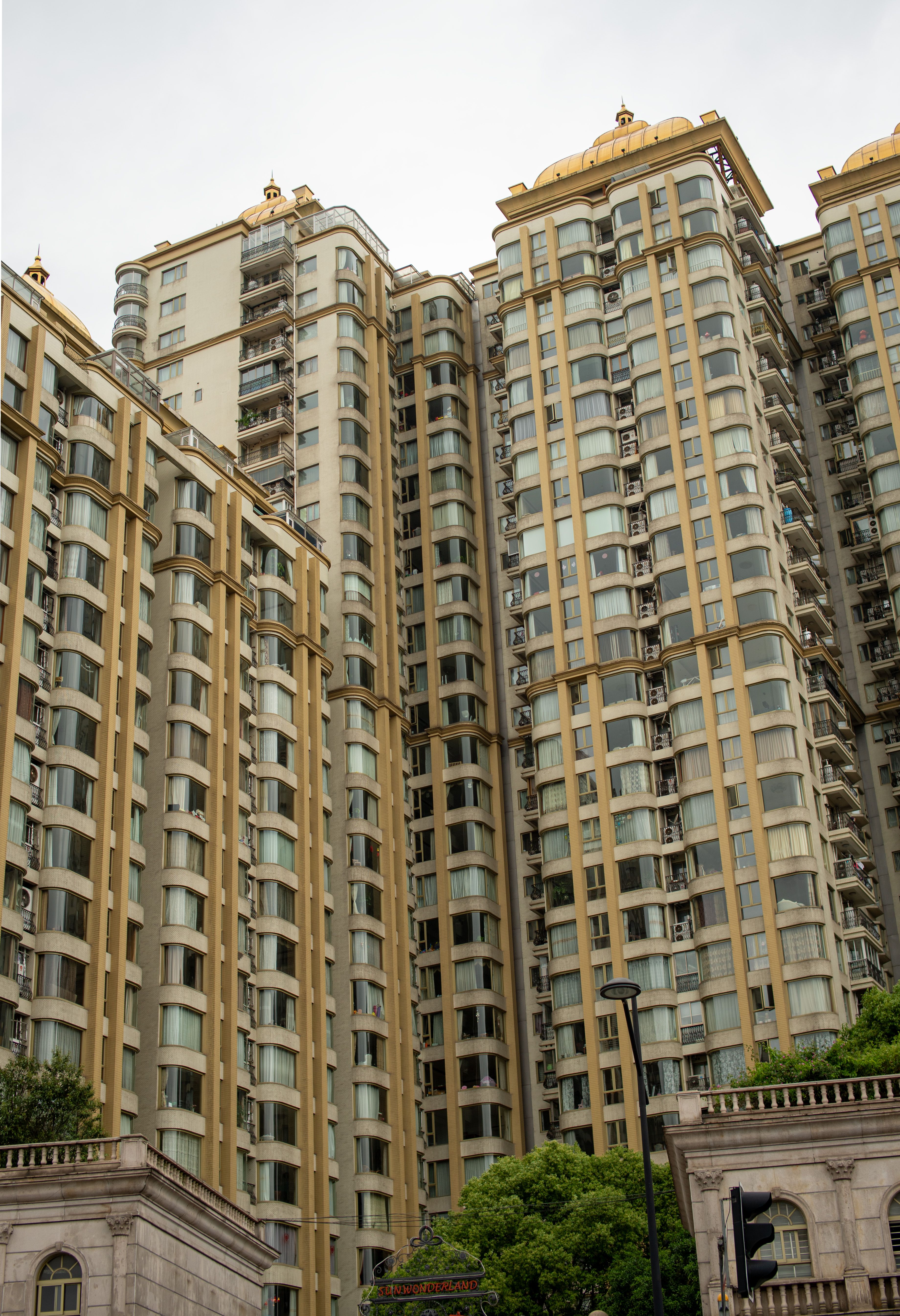 Comparison of Shanghai residential buildings from different eras—old walk-ups versus newer apartments