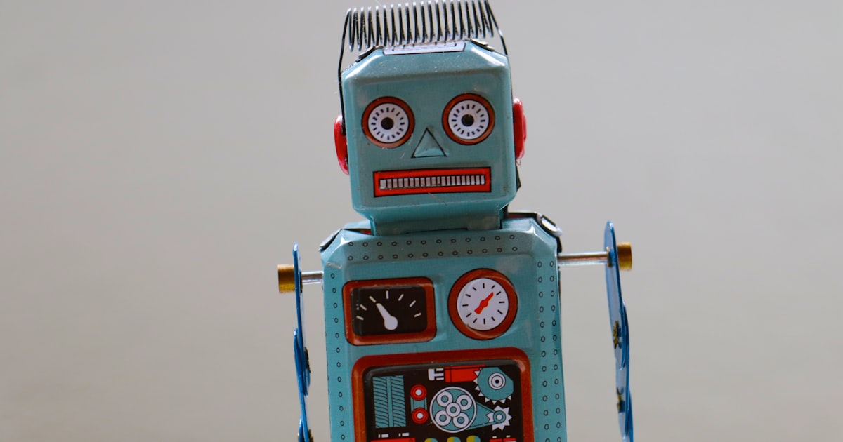 A small blue plastic robot toy, representative of screen-free programmable robotics for early childhood ages 3-5