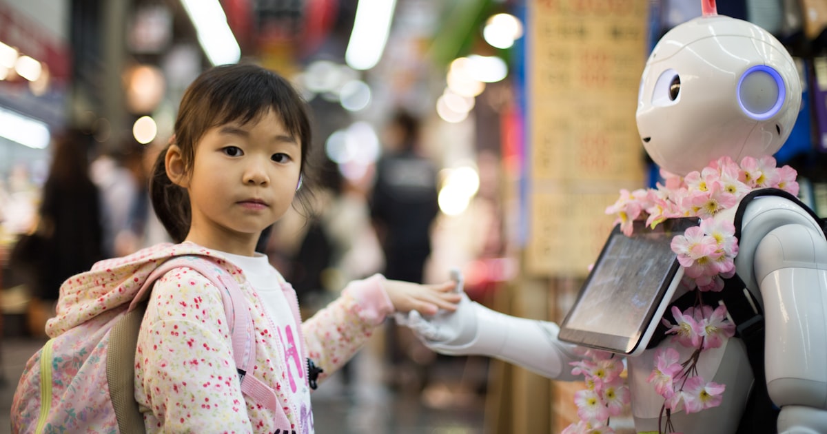 A young Asian girl placing her hand on a white humanoid robot, representing early-childhood AI interaction in Shanghai